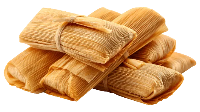 A stack of traditional Mexican tamales wrapped in corn husks