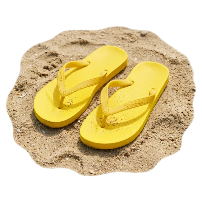 Bright Yellow Flip Flops on Sand