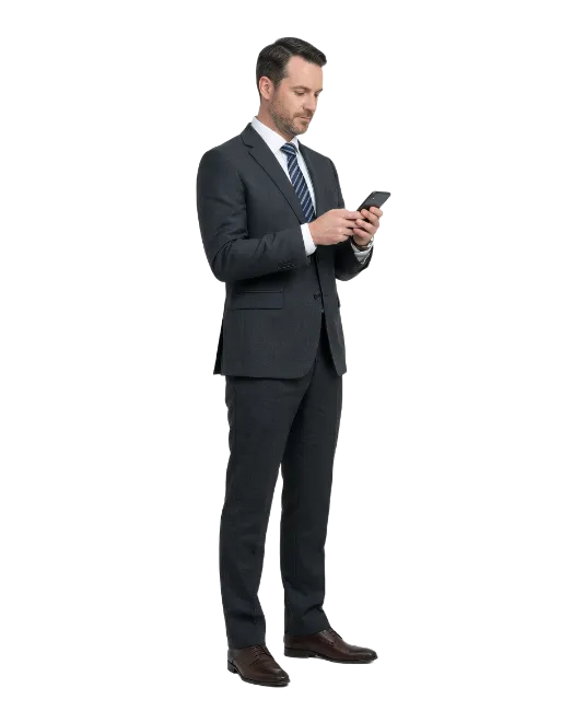 Businessman using smartphone standing profile view