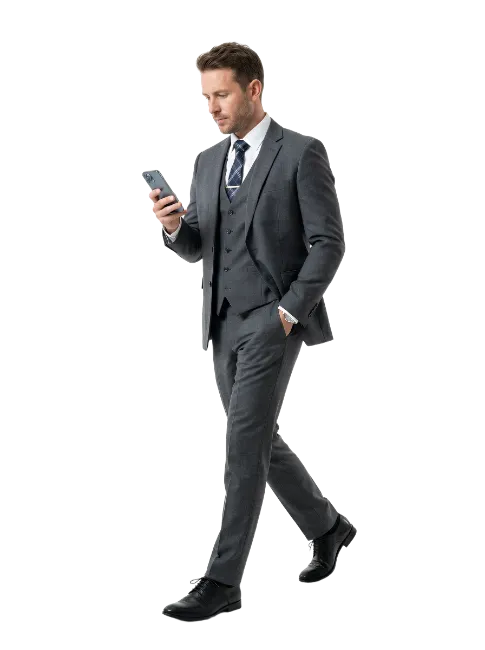 Businessman walking while using smartphone