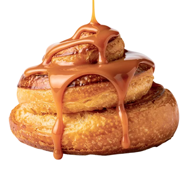Cinnamon roll drizzled with caramel sauce