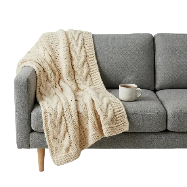 Cozy Knitted Blanket on Gray Sofa