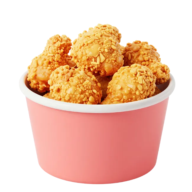 Crispy fried chicken pieces in a pink bucket