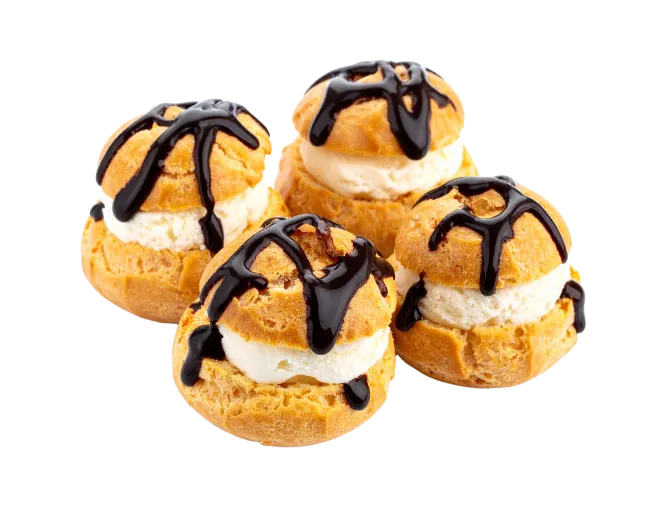 Four Cream Puffs Drizzled With Chocolate Syrup