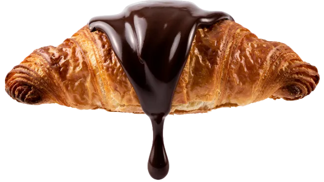 Fresh Croissant Drizzled with Rich Chocolate Syrup
