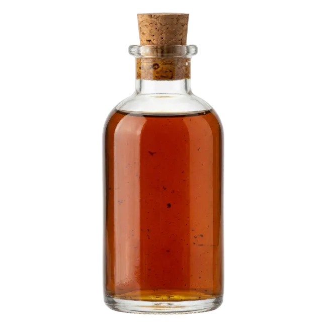Glass Bottle With Cork Containing Amber Liquid