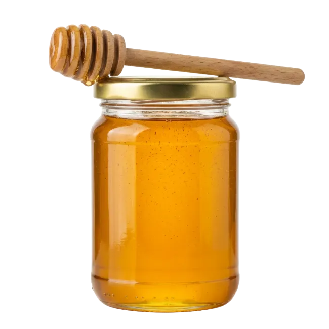Glass jar of golden honey with wooden dipper
