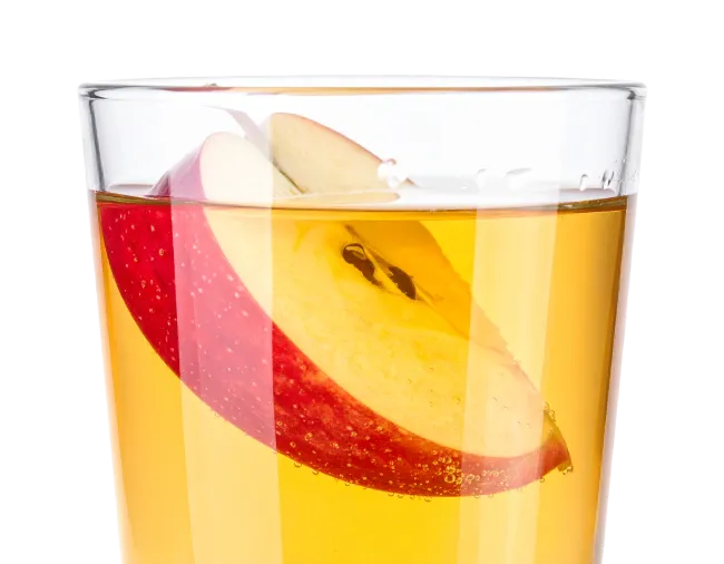 Glass of apple juice with sliced apple