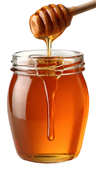 Jar of golden honey with wooden dipper