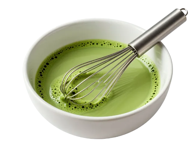 Matcha Tea in White Bowl with Whisk