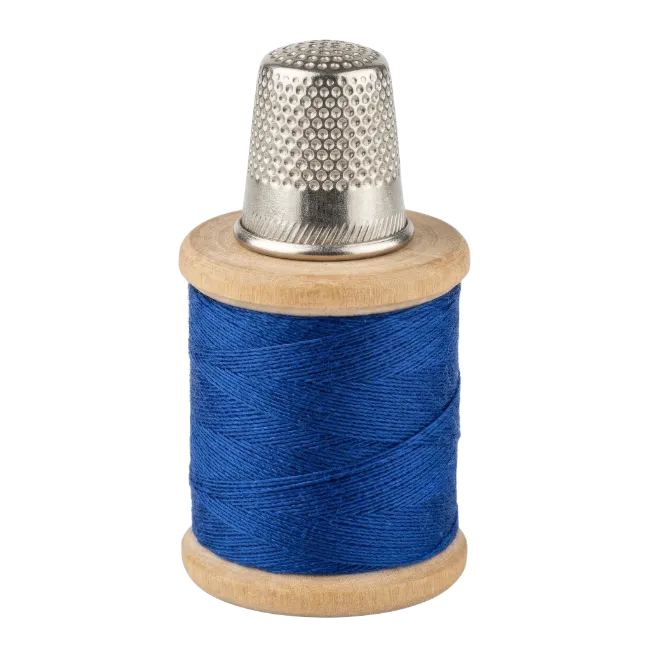 Metal Thimble on Blue Thread Spool