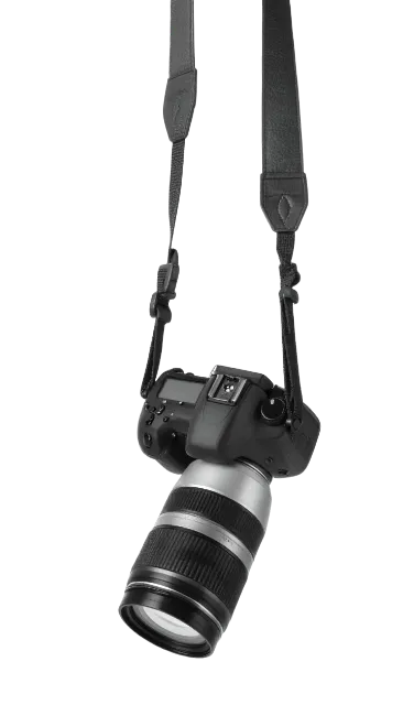 Professional DSLR camera hanging by strap