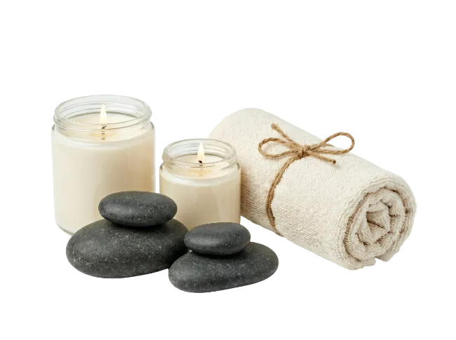 Spa candles, massage stones and rolled towel