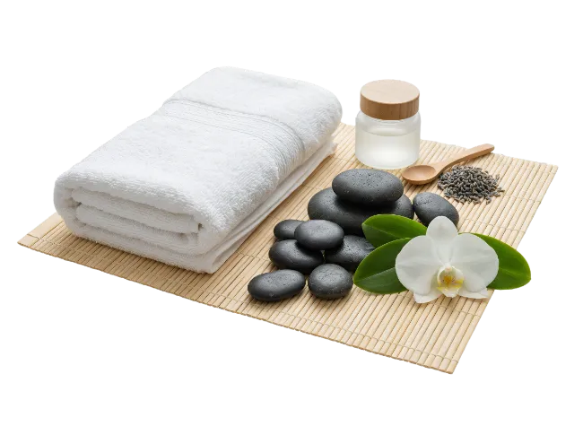 Spa massage stones and white towel on mat