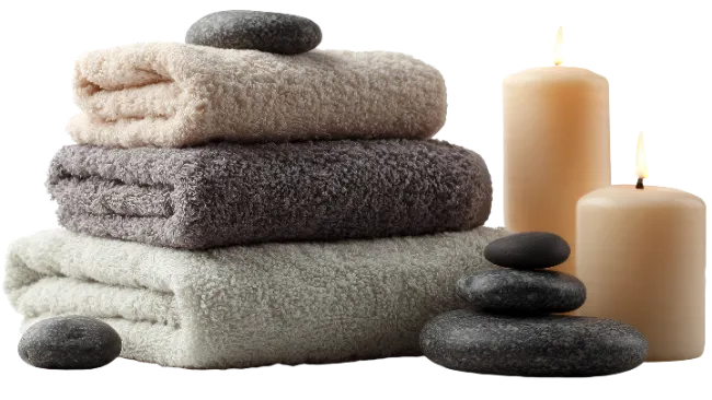 Spa Towels and Lit Candles with Stones