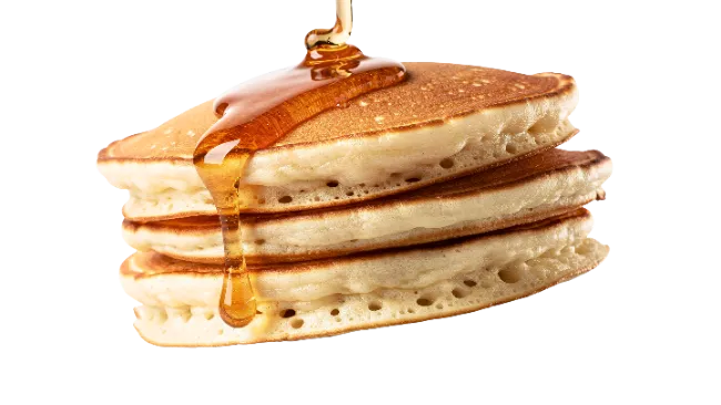 Stack of fluffy pancakes with pouring honey