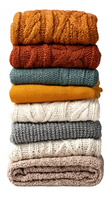 Stack of folded knitted sweaters in various colors