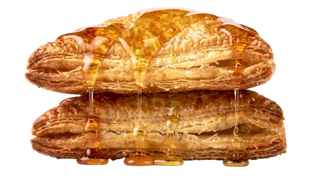 Stacked Flaky Pastries Drenched in Golden Honey