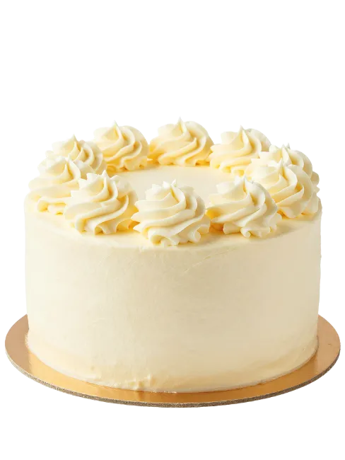 Vanilla frosted layer cake on gold cardboard