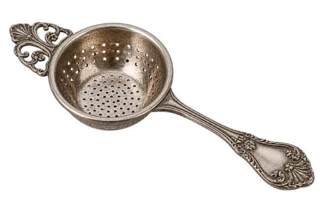 Vintage silver tea strainer with ornate handle