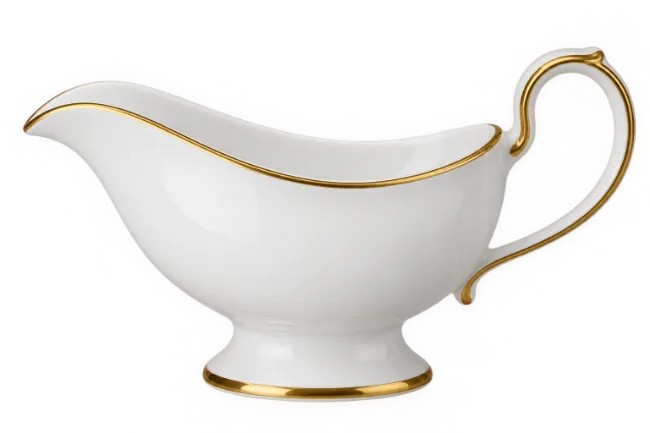 White porcelain gravy boat with gold trim