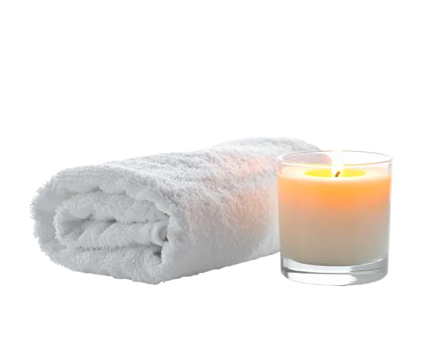 White Rolled Towel and Lit Candle