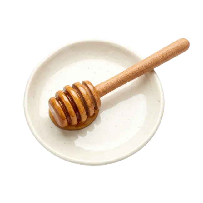 Wooden Honey Dipper on White Ceramic Dish